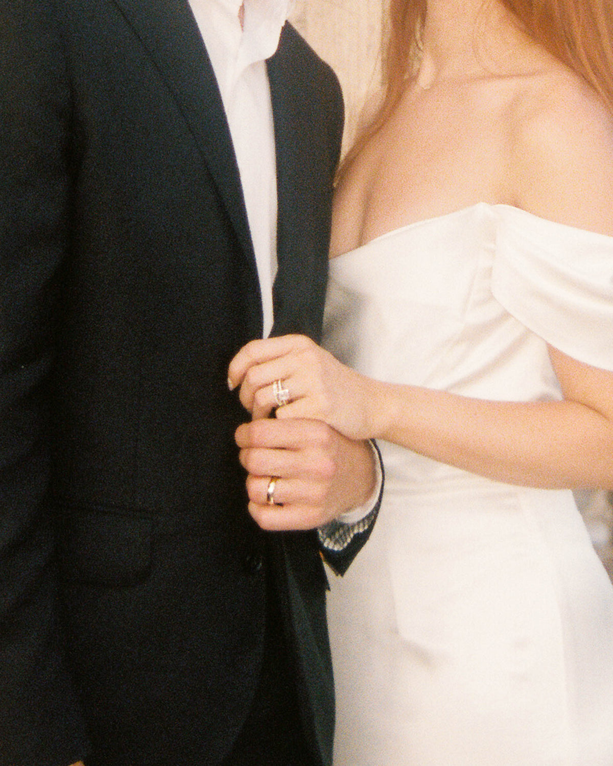 Image of Man And Woman Holding Hands On Wedding Day With Custom Engagement Rings And Wedding Bands